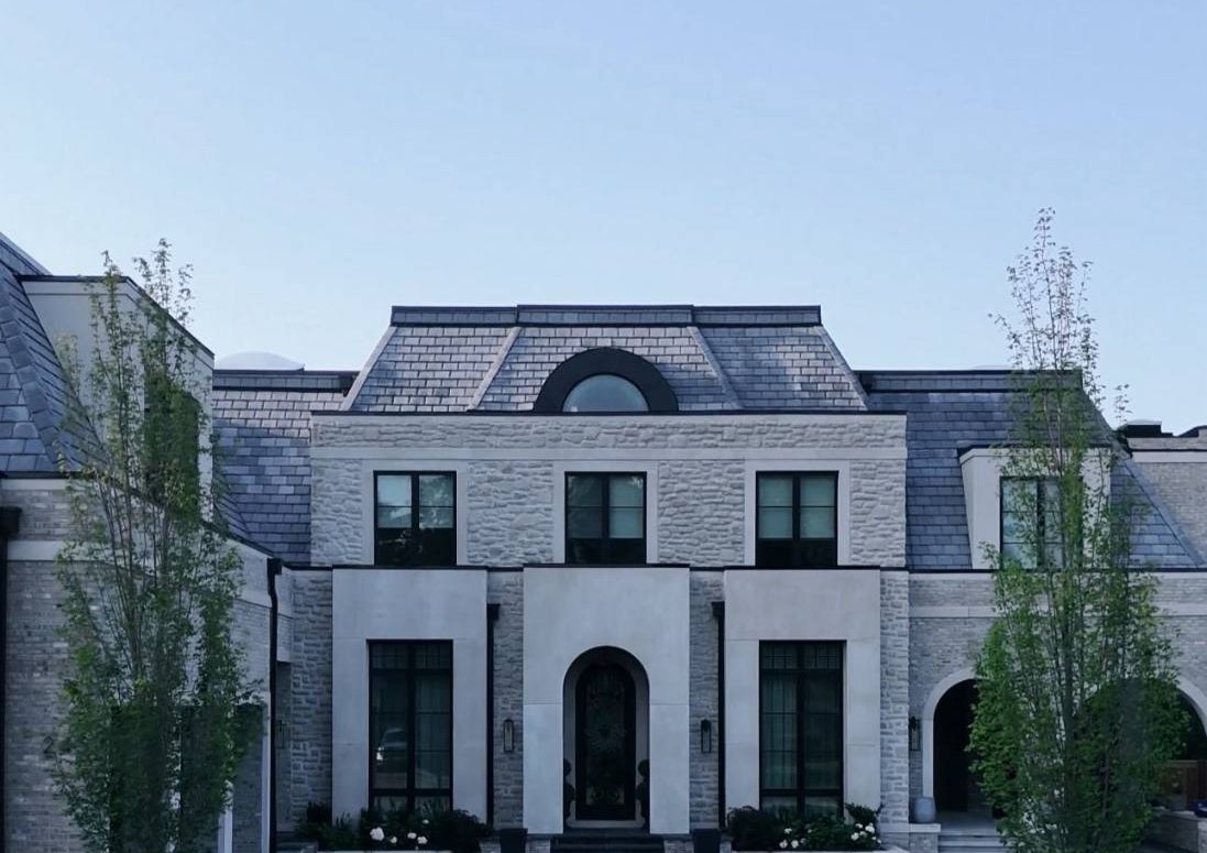 The French Manor on Banner Lane: tumbled limestone, custom architectural precast and a rustic brick, built by BBS Masonry