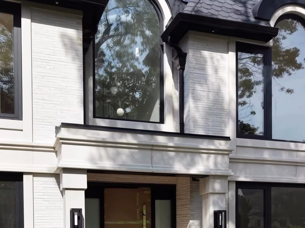 The French Inspired on Tavistock Square, linear brick with crème precast arches at the entrance